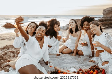 Group of happy group of ladies having fun and drinking wine on beach, taking selfie photo at the hen party on coastline. Enjoying youth and freedom concept - Powered by Shutterstock