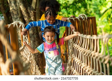Group of Happy Little boy and girl friends playing and climbing rope net together at playground park on summer vacation. Children kid enjoy outdoor activity playing and learning at school playground - Powered by Shutterstock