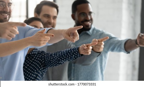 Group of happy multi ethnic people pointing finger aside standing together indoors, close up focus on hands. Human resources hr, choose you got great career opportunity new candidate selection concept - Powered by Shutterstock