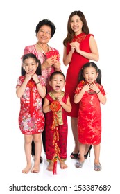 Group Of Happy  Multi Generations Asian Chinese Family Wishing You A Happy Chinese New Year, With Traditional Cheongsam Standing Isolated On White Background.