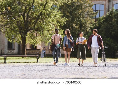 Group Of Happy Multicultural Students Walking Together In Park