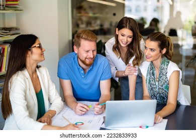Group of happy multiethnic business people working together, sharing ideas in corporate office. - Shutterstock ID 2232833933