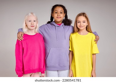 Group of happy multiethnic smiling kids standing together and playing girls black and Caucasian, isolated on white - Powered by Shutterstock