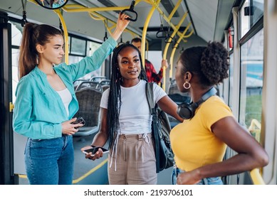 Group of happy multiracial female friends having fun while commuting together by a bus. Happy diverse woman talking while driving in the city bus. Friendship, public transport and people concept. - Powered by Shutterstock