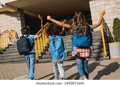 Group of happy multiracial schoolmates elementary middle school kids pupils walking to school together running hurrying to the building for classes lessons. Welcome back to school - Powered by Shutterstock