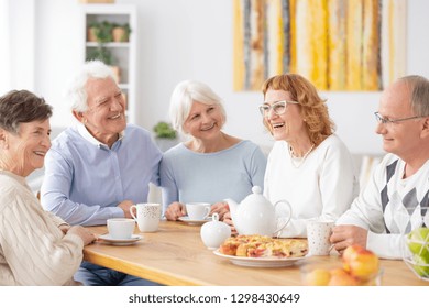 Group Of Happy Older People Laughing Together On A Coffee Meeting At Nursing Home