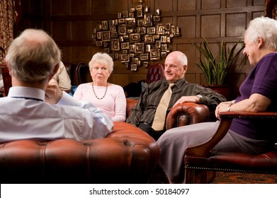 Group Of Happy Older Senior Friends Enjoying Each Others Company In An Expensive Hotel