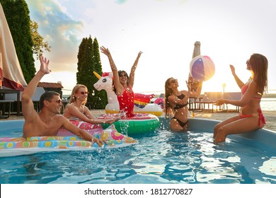 Group of happy people enjoying fun pool party - Powered by Shutterstock