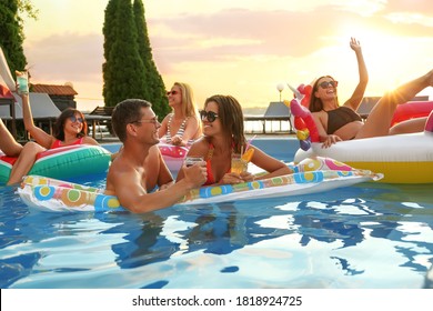 Group of happy people enjoying fun pool party - Powered by Shutterstock