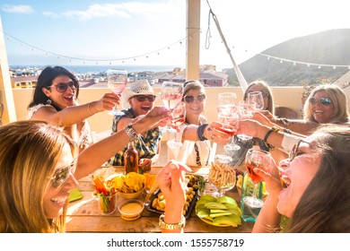 Group Of Happy People Mixed Ages Generations Women Having Fun All Together During Celebration Party - View Of Fiends Clinking And Toasting With Red Wine And Table Full Of Food