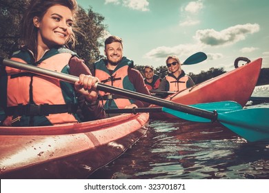 Group Of Happy People On A Kayaks