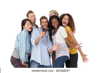 Group Of Happy People Singing Into Microphone Over White Background