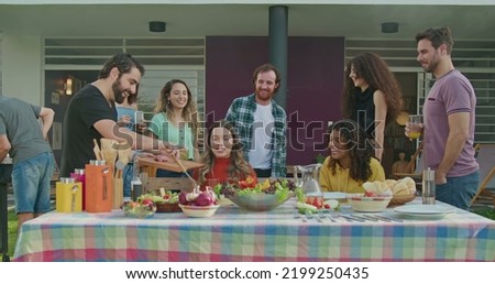 Similar – Gruppe von Freunden, die bei einem Sommergrill kochen.