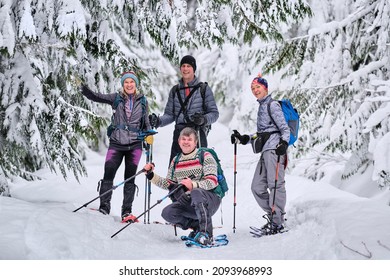 Group Of Happy People Snowshoeing In Winter Forest On Fresh Snow. Smiling Positive Active People. Garibaldi Park. Whistler. British Columbia. Canada