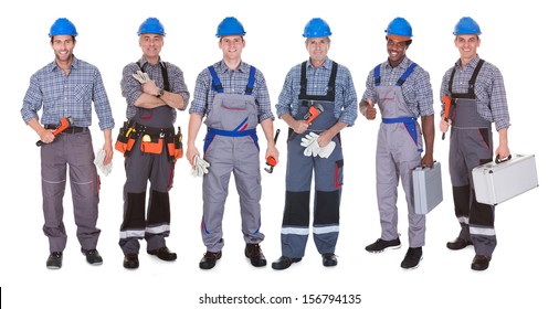 Group Of Happy Plumber Holding Tools Over White Background