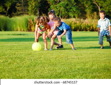 Group Of Happy Preschool Kids Catching The Ball