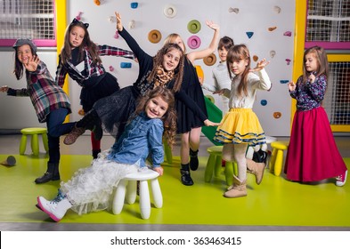 Group Of Happy Preschoolers Dancing In Playroom