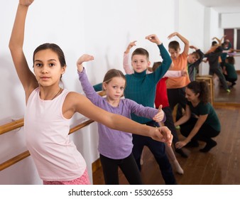 Group Of Happy Russian Children Practicing At The Ballet Barre