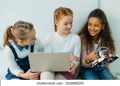 Group Of Happy Schoolgirls Working With Laptop Together On Stem Education Class