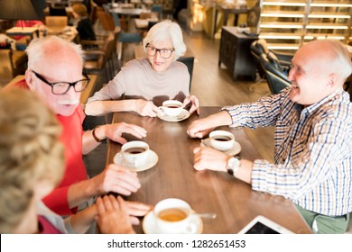 Group of happy senior friends in casual clothing gathering together in cafe to discuss last news and drink tea - Powered by Shutterstock