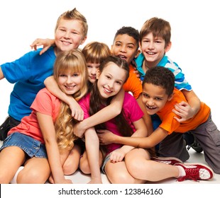 Group of happy smiling kids sitting together and playing - boys and girls black and Caucasian