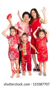 Group Of Happy  Smiling Multi Generations Asian Chinese Family Wishing You A Happy Chinese New Year, With Traditional Cheongsam Standing Isolated On White Background.