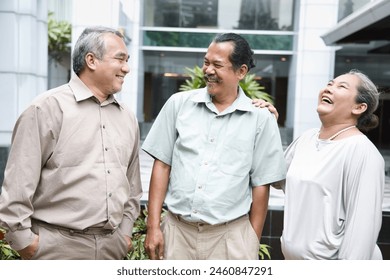 Group of happy smiling old senior friends talking, having a good time together, concept of old friends reuniting with long-lasting friendship - Powered by Shutterstock