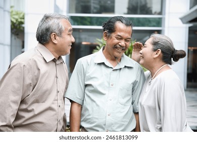 Group of happy smiling old senior friends talking, having a good time together, concept of old friends reuniting with long-lasting friendship - Powered by Shutterstock