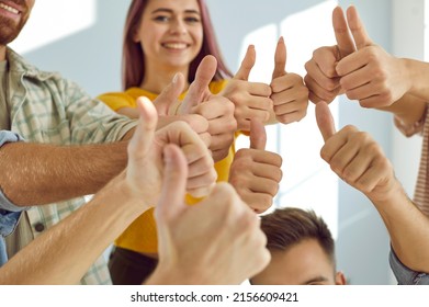 Group Of Happy, Smiling, Young People Giving Thumbs Up All Together. Team Of Cheerful, Satisfied Male And Female University Students Showing That They Agree With A Good Suggestion. Hands Close Up Shot