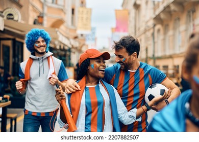 Group Of Happy Soccer Fans Celebrating Their Team's Victory And Having Fun On The Street. 