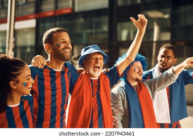 Group Of Happy Soccer Fans Having Fun While Celebrating On The Street During The World Cup.