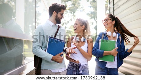 Group of happy students studying, preparing together for exam ourdoor
