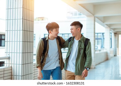 Group of happy students walking along the corridor at college - Powered by Shutterstock