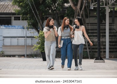 Group of happy students walking along the corridor at college - Powered by Shutterstock