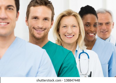 Group Of Happy Successful Doctors Standing In A Row At Hospital