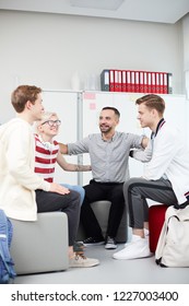 Group Of Happy Teens And Their Teacher Sitting In Circle And Having Team Discussion