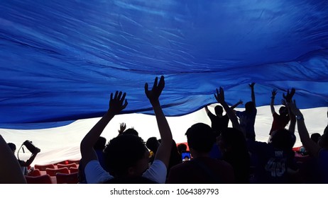 Group Of Happy Thailand Soccer Fans Silhouette At Stadium,cheer By Doing The Waves With National Flag.