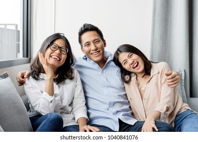 Group Of Happy Three Asian Best Friends In Casual Wear Laughing And Smiling Together In Living Room
