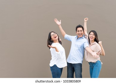 Group Of Happy Three Asian Friends In Casual Wear Standing Laugh And Having Fun Together