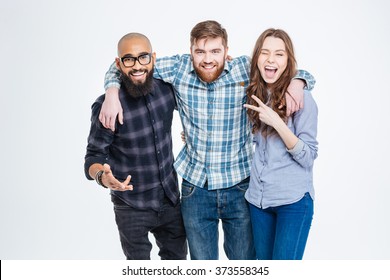 Group of happy three friends in casual wear standing and laughing 