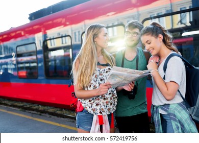 Group of happy tourists traveling by train