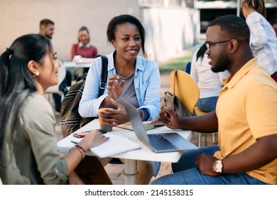 Group Of Happy University Students Communicating On Their Coffee Break At Cafeteria Outdoors. Focus Is On African America Female Student. 