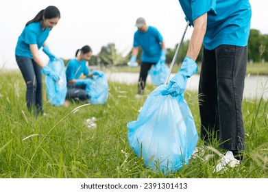 A group of happy volunteers cleaned up the riverside by collecting garbage into garbage bags and separating plastic waste from water bottles. Help keep nature clean. Reduce environmental pollution - Powered by Shutterstock