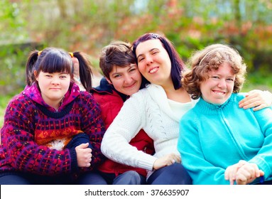 group of happy women with disability having fun in spring park