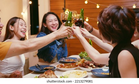 Group Of Happy Young Asian People With Friends Celebrating Clinking Glasses During Dinner Party