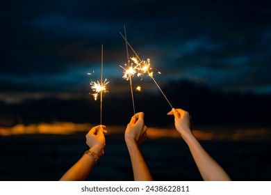 Group of Happy Young Asian woman playing sparklers firework together at tropical beach in summer night. Attractive girl enjoy and fun outdoor lifestyle travel ocean nightlife party on holiday vacation - Powered by Shutterstock