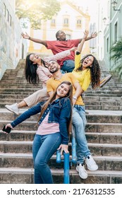 Group of happy young brazilian friends having fun sitting on the handrail of a stairs in the city center - Friendship concept - Focus on the bearded man

 - Shutterstock ID 2176312535