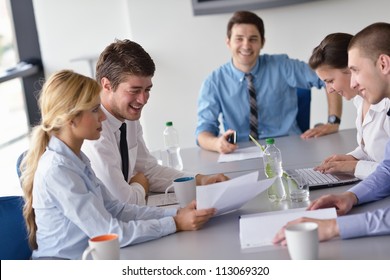Group of happy young  business people in a meeting at office - Shutterstock ID 113069320