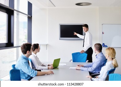Group of happy young  business people in a meeting at office - Shutterstock ID 113428807