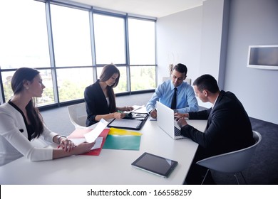 Group of happy young  business people in a meeting at office - Shutterstock ID 166558259